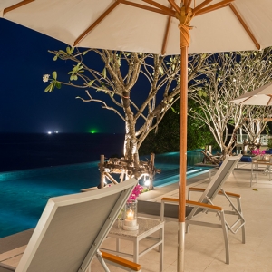 The Aquila - Nighttime over main pool with ocean backdrop